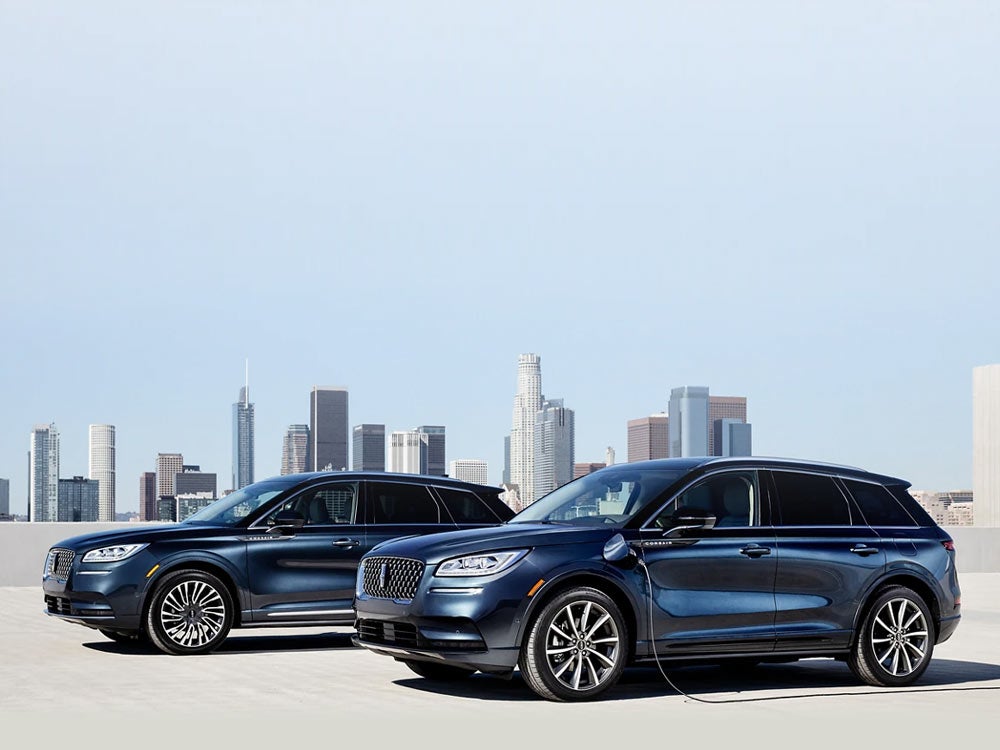 A Lincoln Corsair® Grand Touring SUV and a Lincoln Corsair Reserve model are parked next to each other on a rooftop