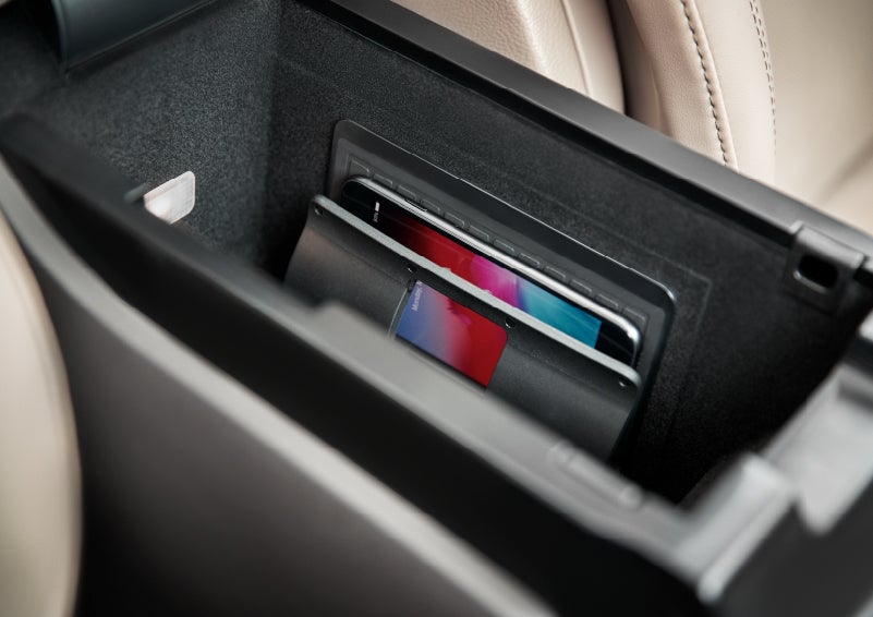 A smartphone device is securely tucked into the available wireless charging pad for an effortless energy boost | Klaben Lincoln of Warren in Warren OH