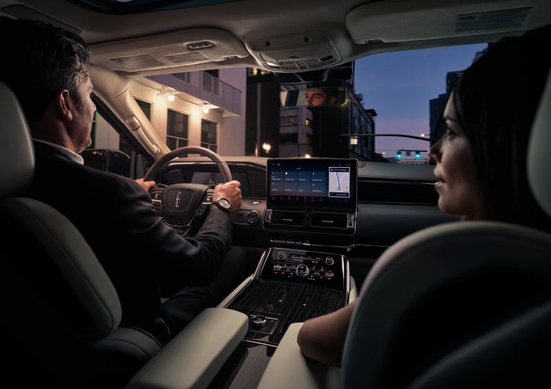 A couple is relaxing inside their quiet and serene 2022 Lincoln Navigator SUV | Klaben Lincoln of Warren in Warren OH