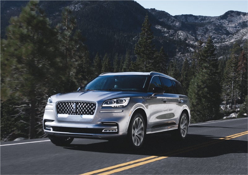 A 2023 Lincoln Aviator® Grand Touring SUV being driven on a winding road to demonstrate the capabilities of all-wheel drive | Klaben Lincoln of Warren in Warren OH