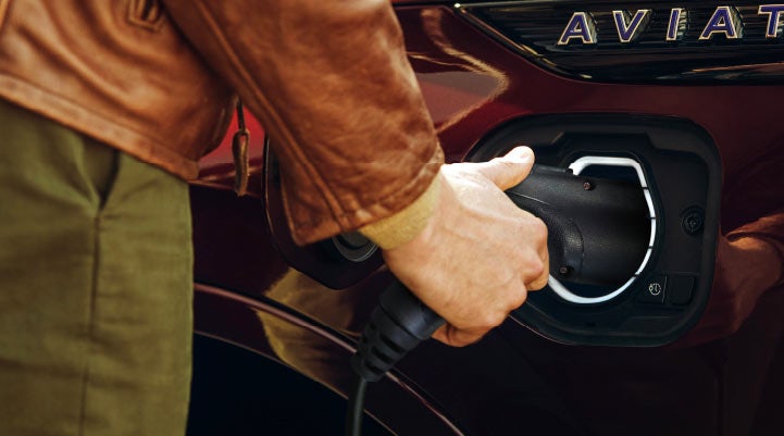 A hand is shown plugging in the charger into the charging port of a 2021 Lincoln Aviator | Klaben Lincoln of Warren in Warren OH