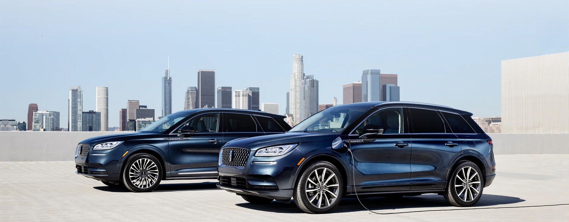 A Lincoln Corsair® Grand Touring SUV and a Lincoln Corsair Reserve model are parked next to each other on a rooftop