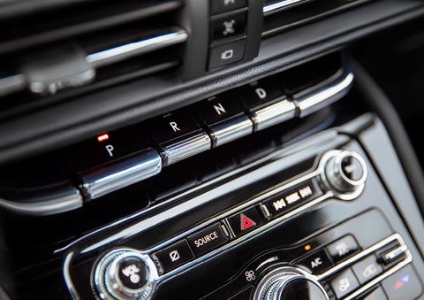 The Park button on the elegant Piano Key Shifter is lit up and engaged as light dances off the chrome accents and horizontal design lines | Klaben Lincoln of Warren in Warren OH