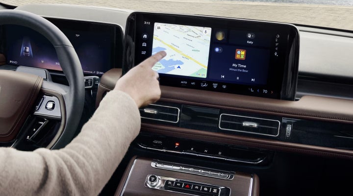 A person is tapping the center display touchscreen of a 2026 Lincoln Aviator® SUV. | Klaben Lincoln of Warren in Warren OH