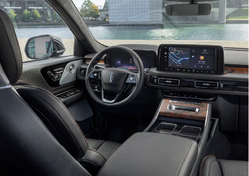 The interior of the 2026 Lincoln Aviator® SUV is shown parked with a view of a harbor through the windshield. | Klaben Lincoln of Warren in Warren OH