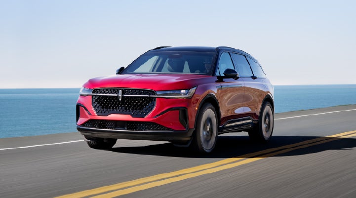 A 2026 Lincoln Nautilus® SUV is being driven on a seaside roadway. | Klaben Lincoln of Warren in Warren OH