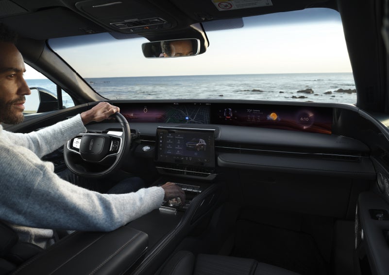 A driver of a parked 2026 Lincoln Nautilus® SUV takes a relaxing moment at a seaside overlook while inside his Nautilus. | Klaben Lincoln of Warren in Warren OH