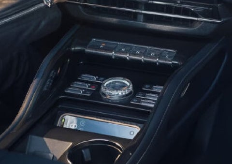 A smartphone is shown charging in the wireless charging pad. | Klaben Lincoln of Warren in Warren OH
