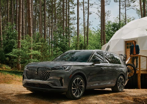 A 2027 Lincoln Aviator® is parked next to a high end glamping site. | Klaben Lincoln of Warren in Warren OH