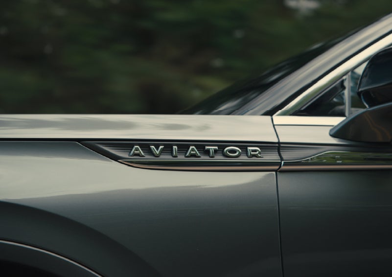 The driver’s side door and fender badging of a gray 2027 Lincoln Aviator® SUV are showcased. | Klaben Lincoln of Warren in Warren OH