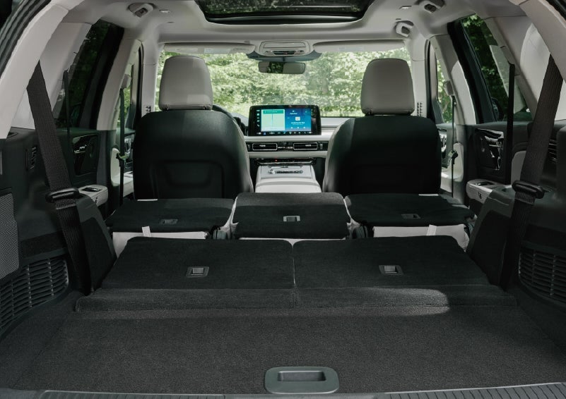 A rear to front view of the interior of a 2027 Lincoln Aviator® Black Label™ SUV shows the third and second rows folded flat | Klaben Lincoln of Warren in Warren OH