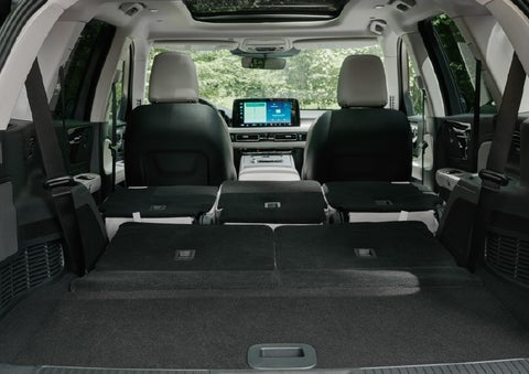 A rear to front view of the interior of a 2027 Lincoln Aviator® Black Label™ SUV shows the third and second rows folded flat | Klaben Lincoln of Warren in Warren OH