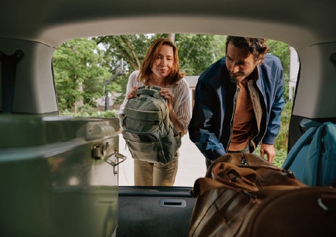 A couple loads luggage into the rear of a 2027 Lincoln Aviator® Black Label™ SUV..e 202 | Klaben Lincoln of Warren in Warren OH